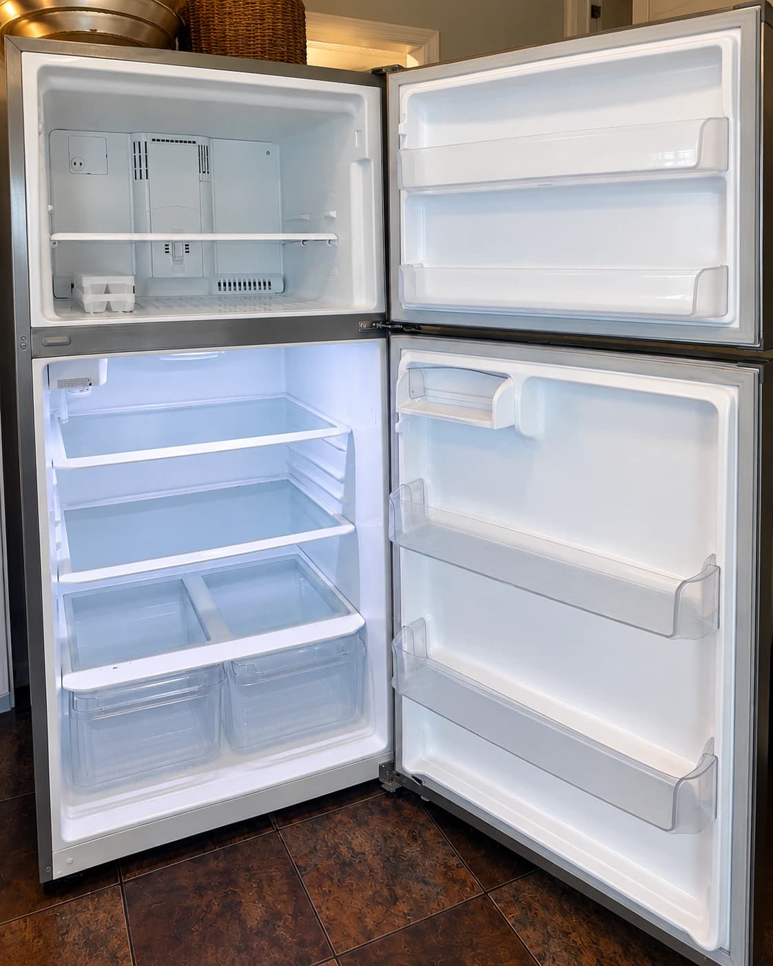 The same refrigerator after cleaning, with shelves, drawers and door bins clean and bright.